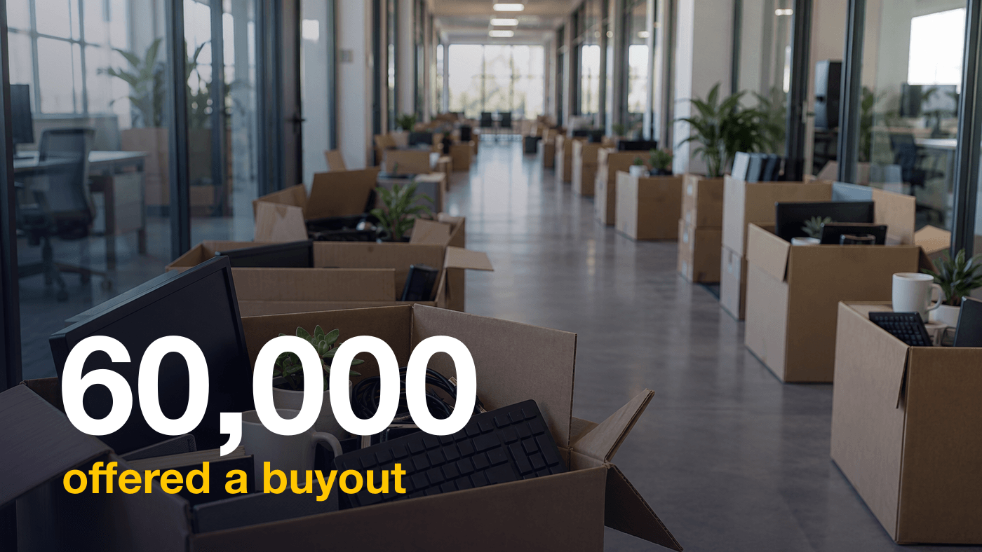 Open cardboard boxes half packed with desk belongings, a mug, a keyboard and a small plant, lined along a glass walled office corridor