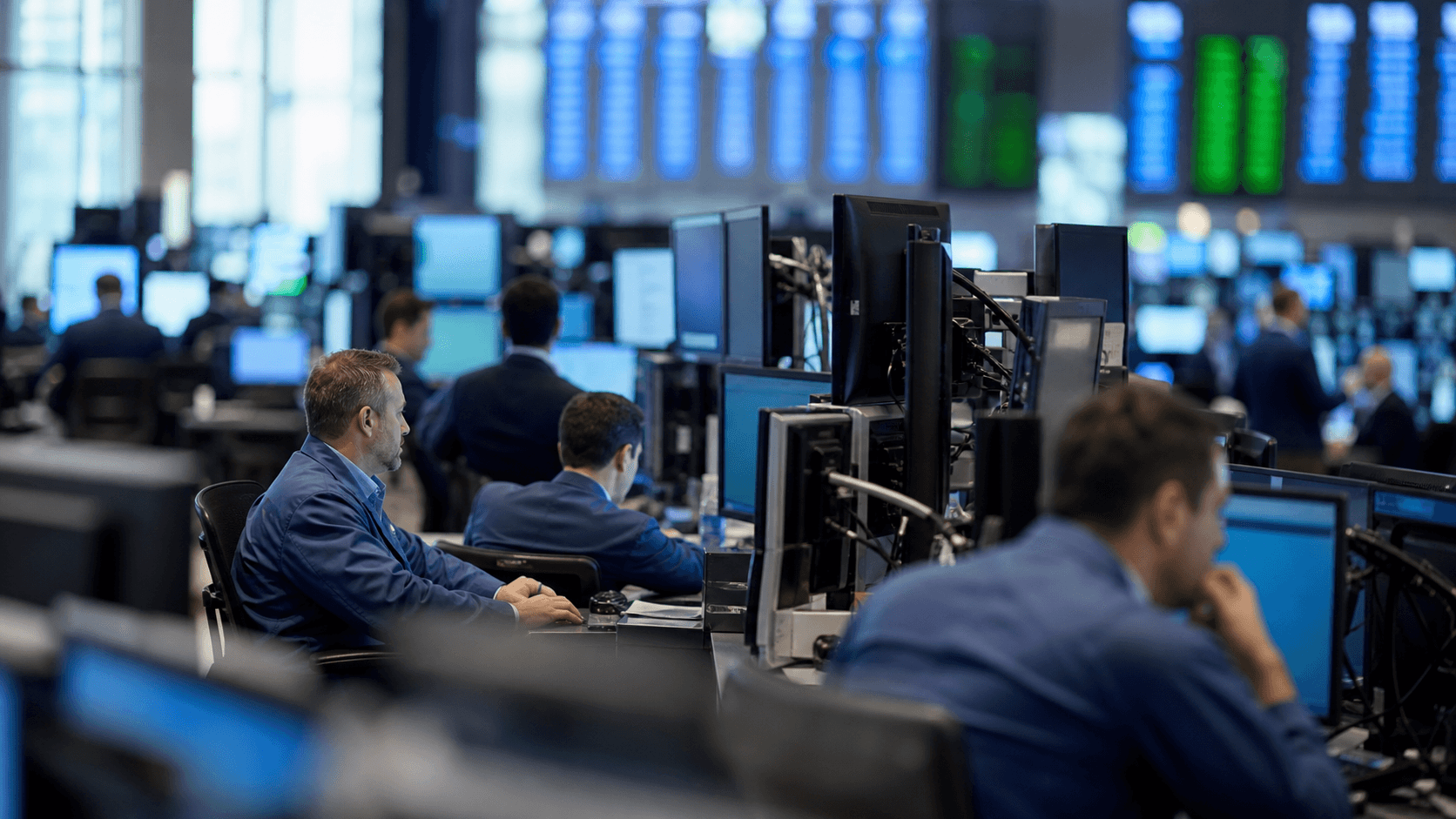 Traders working on a financial trading floor at the morning market open as major stock indexes rebalance